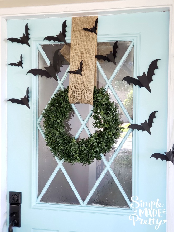 Keep your Halloween front door decorations simple this year while creating spooky Halloween decorations for your Fall front door.  These are creative ideas for homemade Halloween decor that's also cheap Halloween decor and goes with a teal blue front door. The result is Simple Halloween Front Porch Decor that adds the perfect touch of Halloween outdoor decorations. #halloweenfrontporchdecor #DIYHalloweendecor 