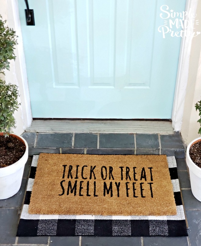 Keep your Halloween front door decorations simple this year while creating spooky Halloween decorations for your Fall front door.  These are creative ideas for homemade Halloween decor that's also cheap Halloween decor and goes with a teal blue front door. The result is Simple Halloween Front Porch Decor that adds the perfect touch of Halloween outdoor decorations. #halloweenfrontporchdecor #DIYHalloweendecor