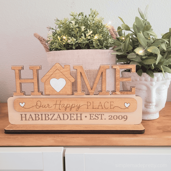 Personalized interchangeable HOME sign kit with removable shapes and quote plaque on a tabletop display